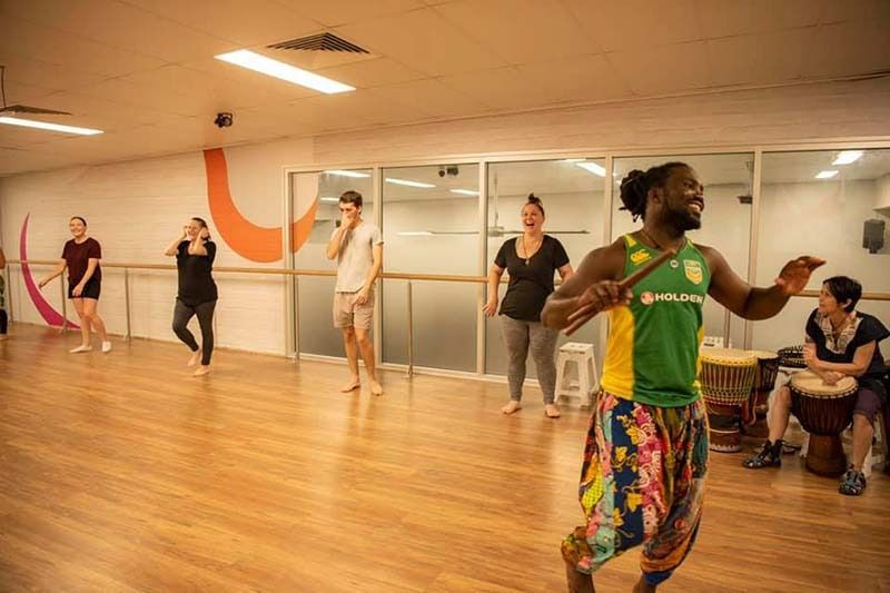 A Group Of People Are Dancing In A Dance Studio — Global Dance Collective In West End, QLD