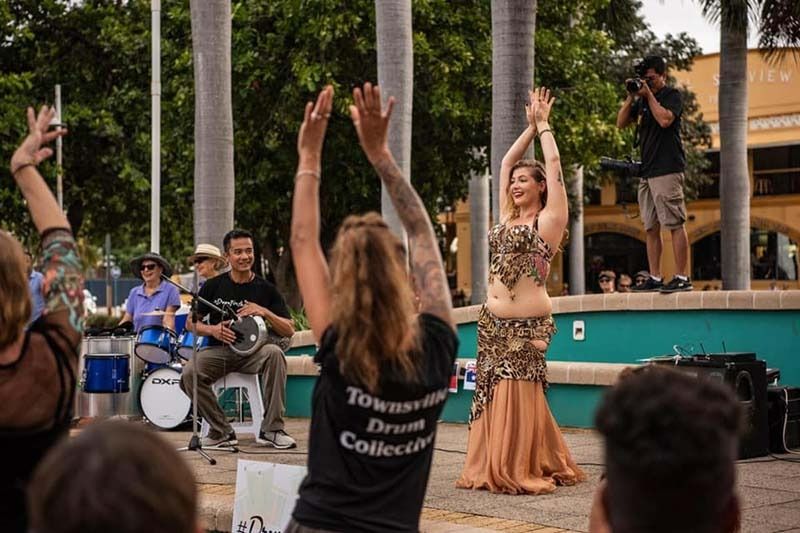 A Group Of People Are Watching A Belly Dancer Perform On A Stage — Global Dance Collective In West End, QLD