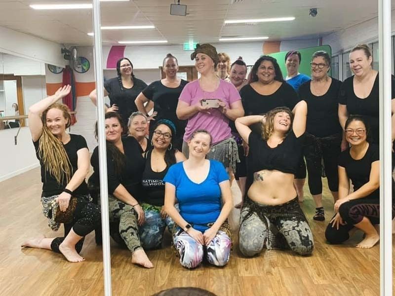 A Group Of Women Are Posing For A Picture In Front Of A Mirror — Global Dance Collective In West End, QLD