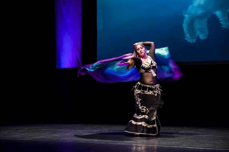 A Woman Is Dancing On A Stage In Front Of A Large Screen — Global Dance Collective In West End, QLD