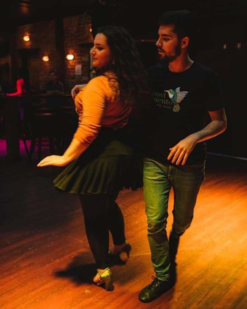 A Man And A Woman Are Dancing Together In A Dark Room — Global Dance Collective In West End, QLD