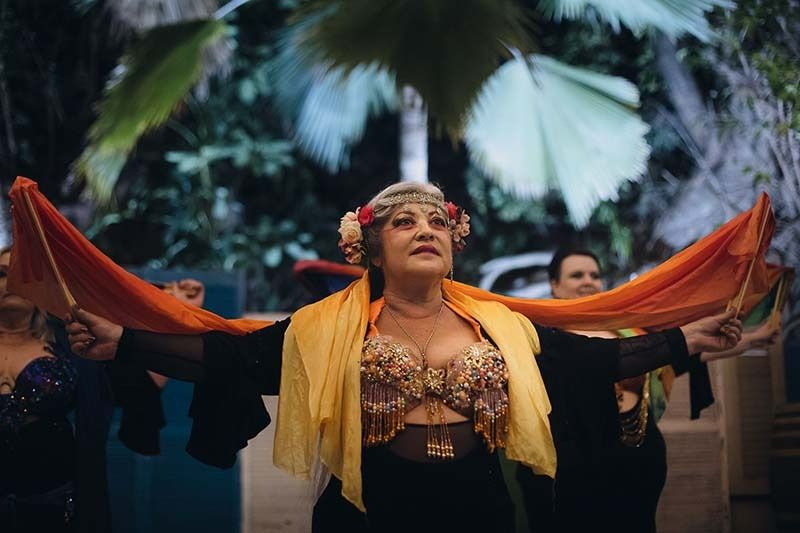 A Woman Is Dancing With Her Arms Outstretched In Front Of A Group Of People — Global Dance Collective In West End, QLD