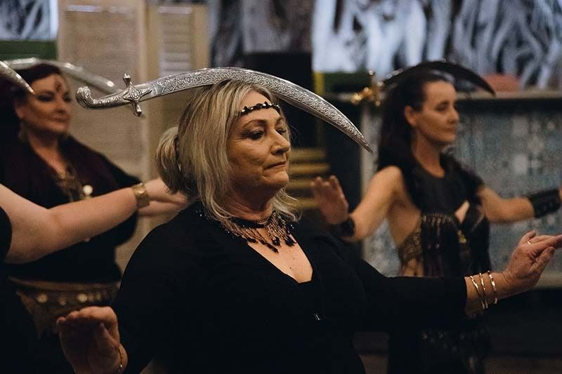 A Group Of Women Are Dancing With Swords In Their Hands — Global Dance Collective In West End, QLD