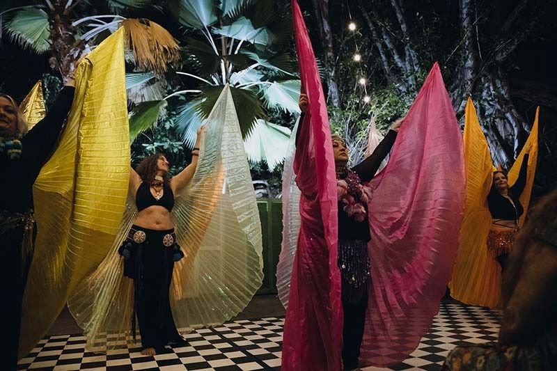 A Group Of Women Are Dancing With Wings On A Checkered Floor — Global Dance Collective In West End, QLD