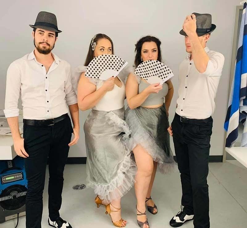 A Group Of People Standing Next To Each Other Holding Fans — Global Dance Collective In West End, QLD