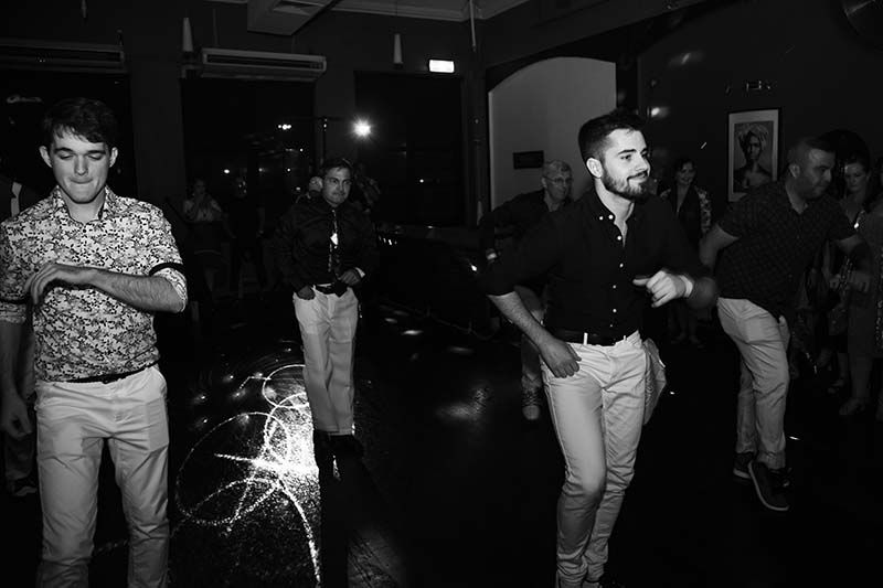 A Group Of Men Are Dancing In A Room In A Black And White Photo — Global Dance Collective In West End, QLD