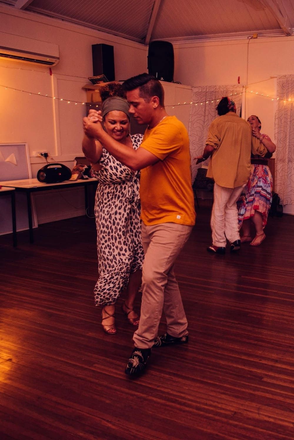 A Man And A Woman Are Dancing On A Wooden Floor In A Room — Global Dance Collective In West End, QLD