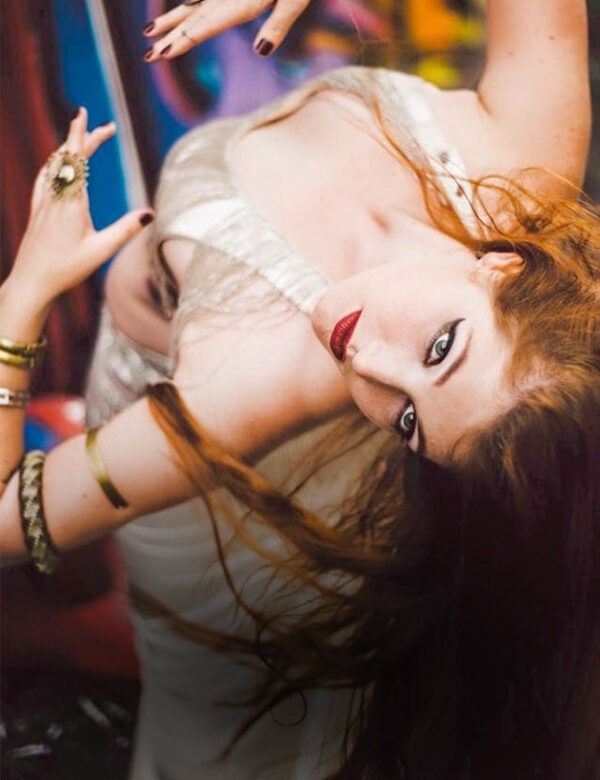 A Woman In A White Dress Is Laying On Her Back — Global Dance Collective In West End, QLD