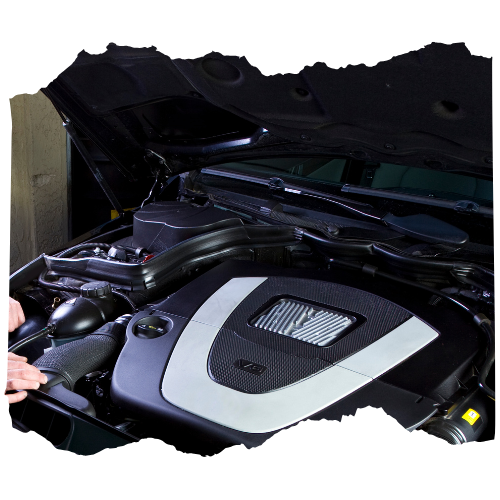 A person is working on the engine of a car