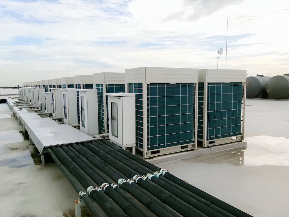 A Row Of Air Conditioners Are Sitting On Top Of A Roof — Mason's Air Conditioning Pty Ltd in Gatton, QLD