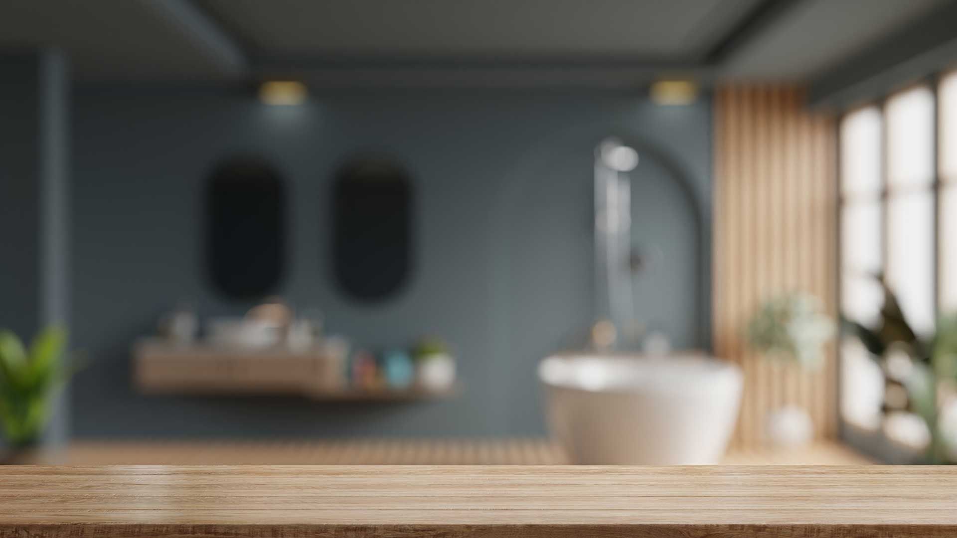 Blurred modern bathroom interior with wooden countertop, sink, mirror, and plants by a bright window