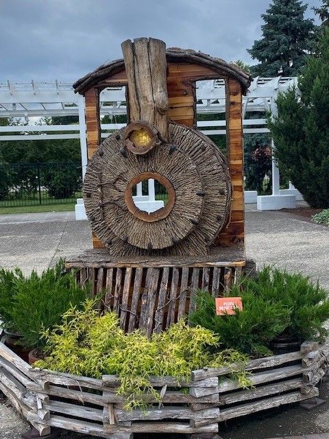 a statue of a train engine made out of logs