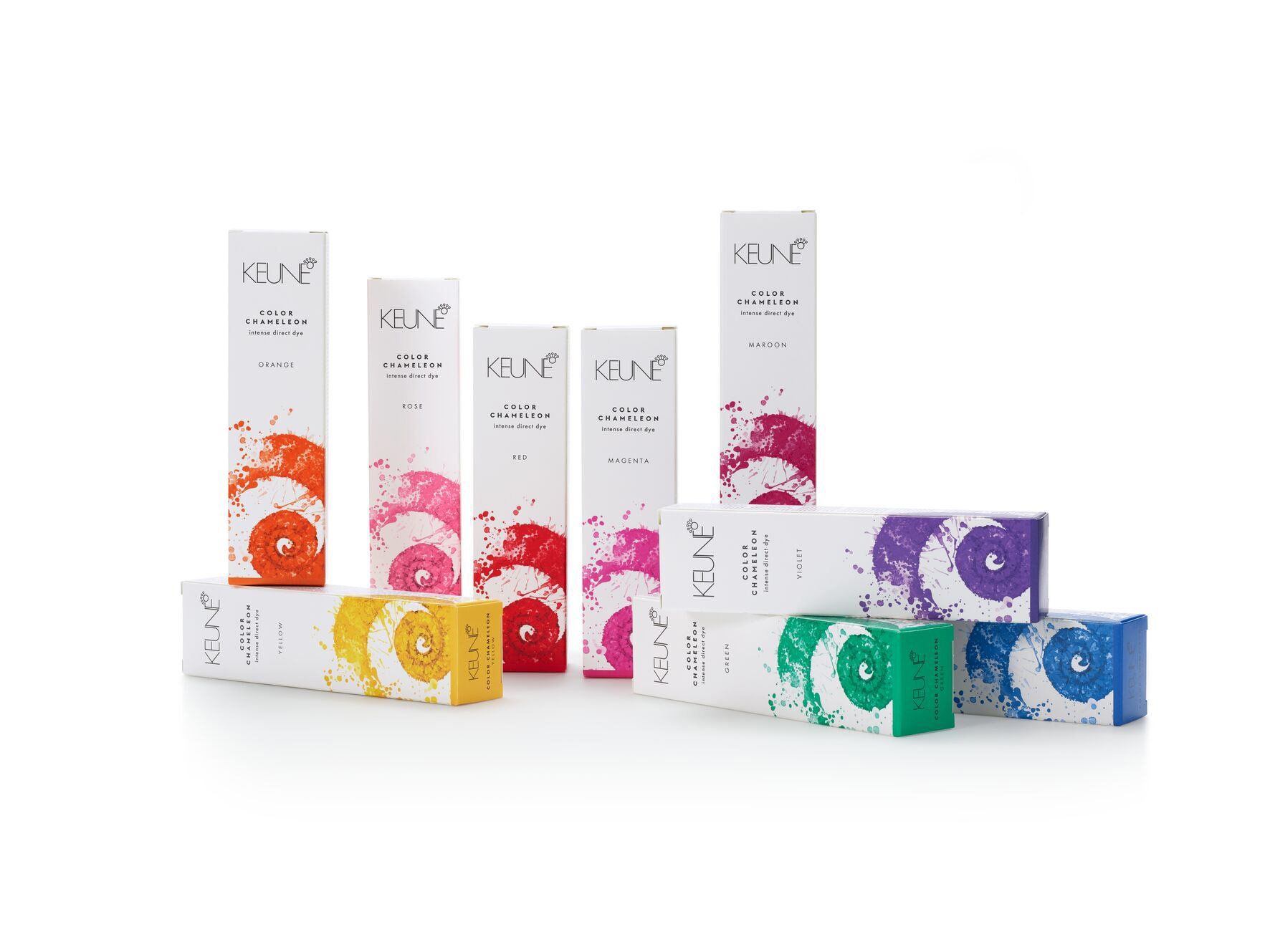 Cosmetic product boxes, various colors, stacked and arranged against a white background.