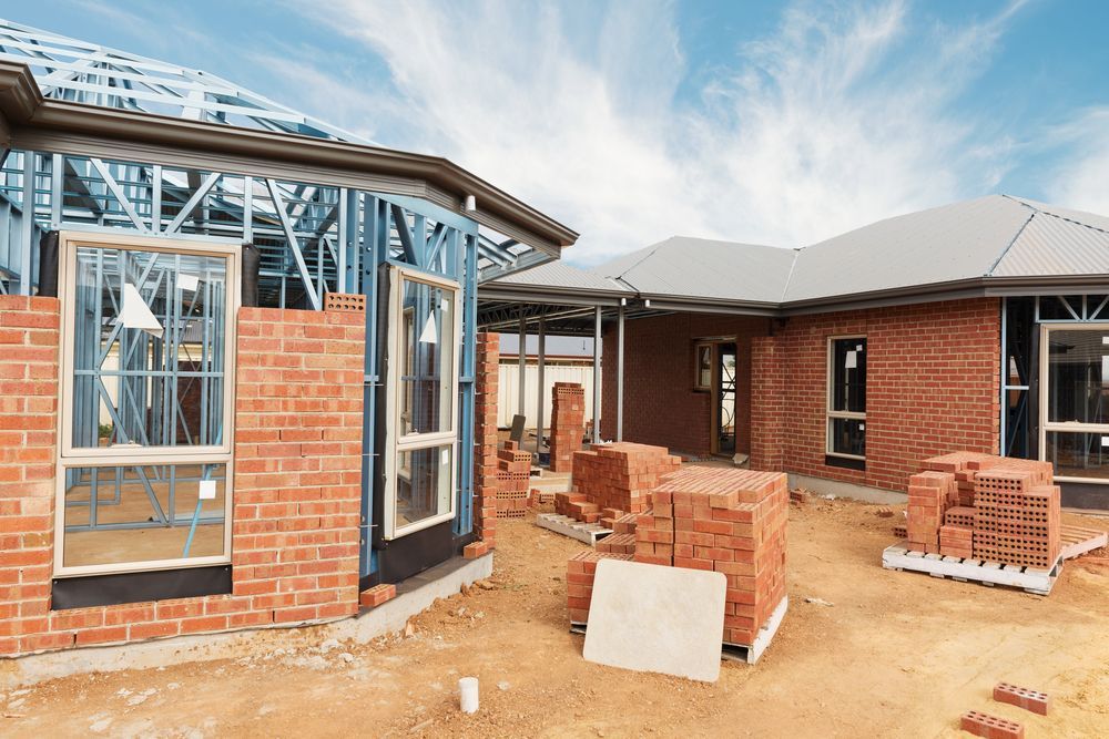 A House Is Being Built With Bricks And A Metal Frame — Heritage Bricklaying & Remedial Services In Toukley, NSW