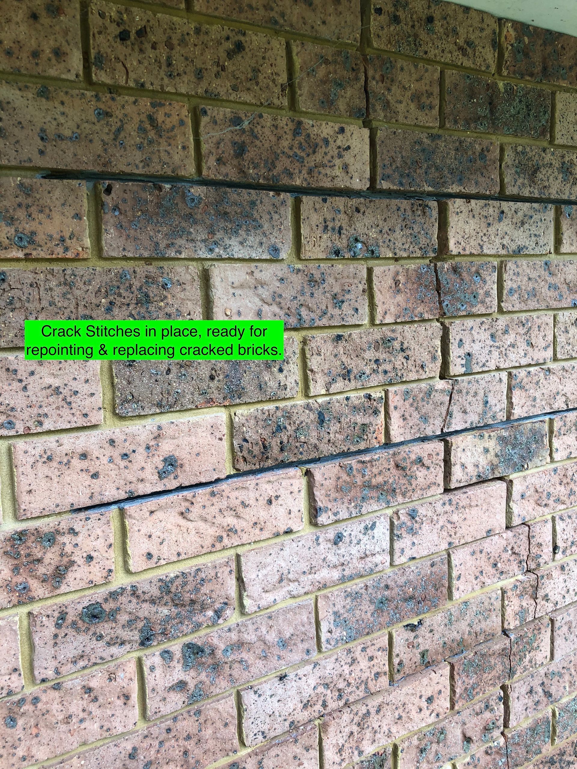 A Large Brick House With A White Garage Door And Two Windows — Heritage Bricklaying & Remedial Services In Jilliby, NSW