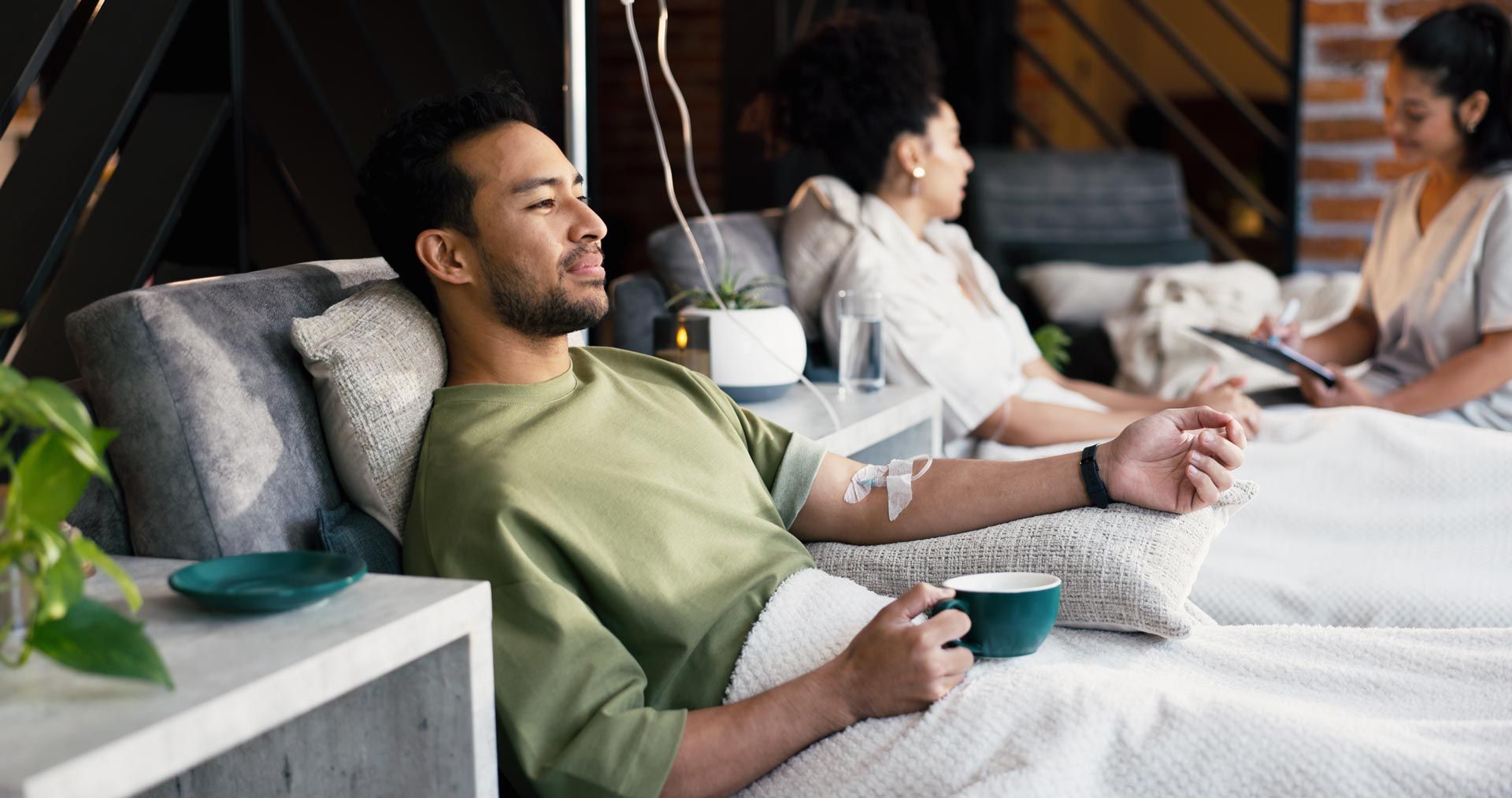 People relaxing on lounge chairs with drinks in a modern spa-like lounge