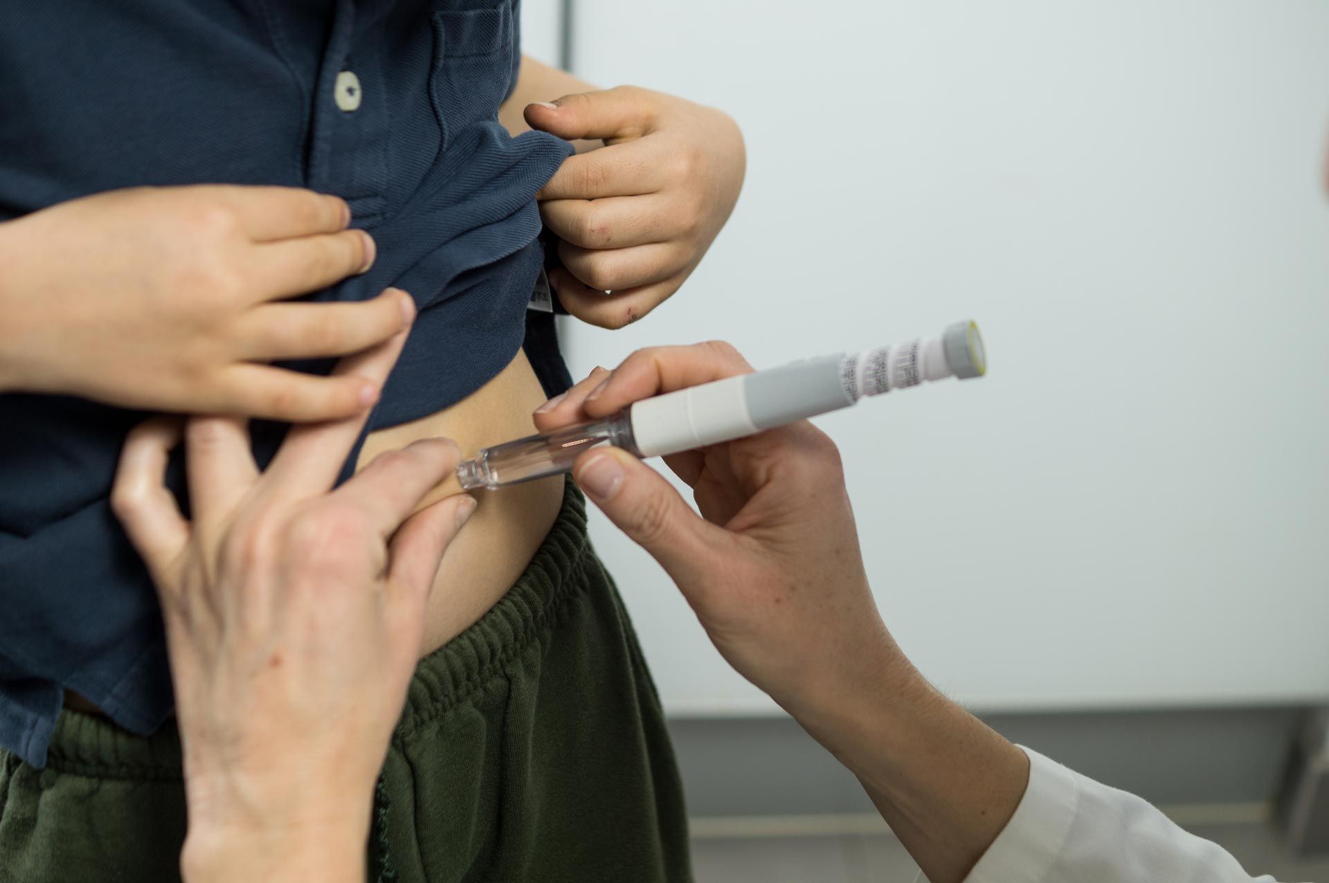 Healthcare worker giving an injection to a child’s arm