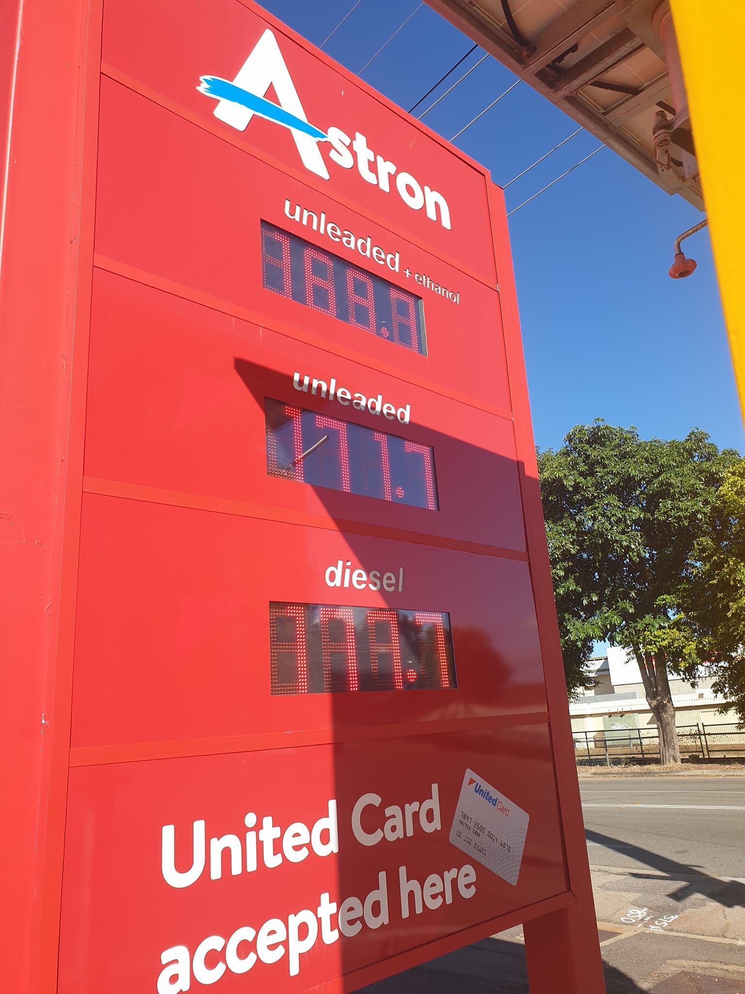 Red Astron gas price sign with fuel prices displayed. 