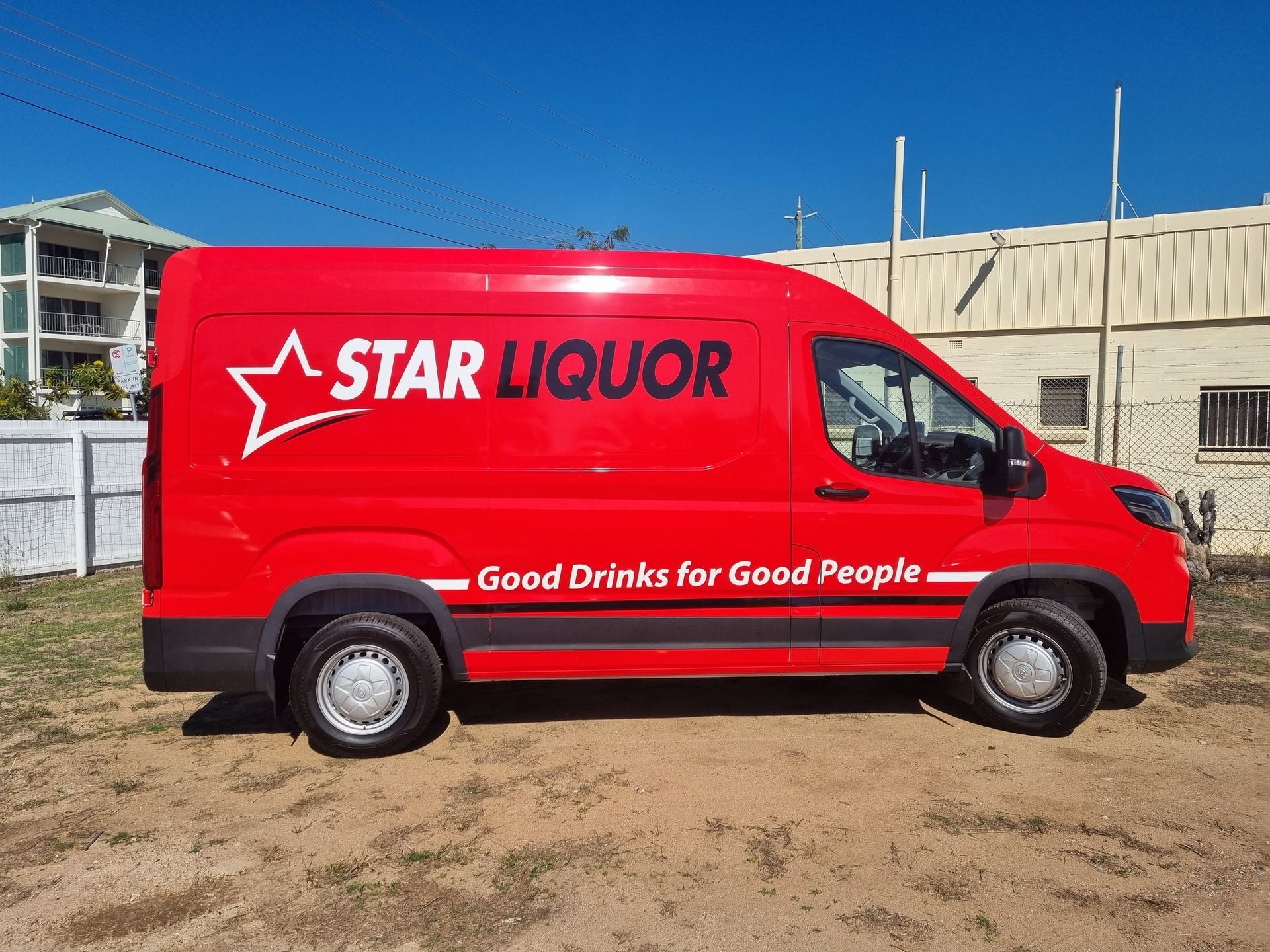 Red Star Liquor van parked outdoors, white text/star logo, 