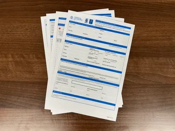 A stack of papers sitting on top of a wooden table.