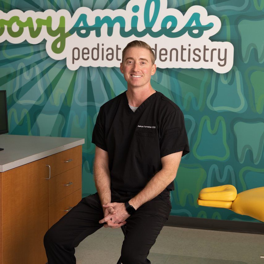 Dentist sits in office with