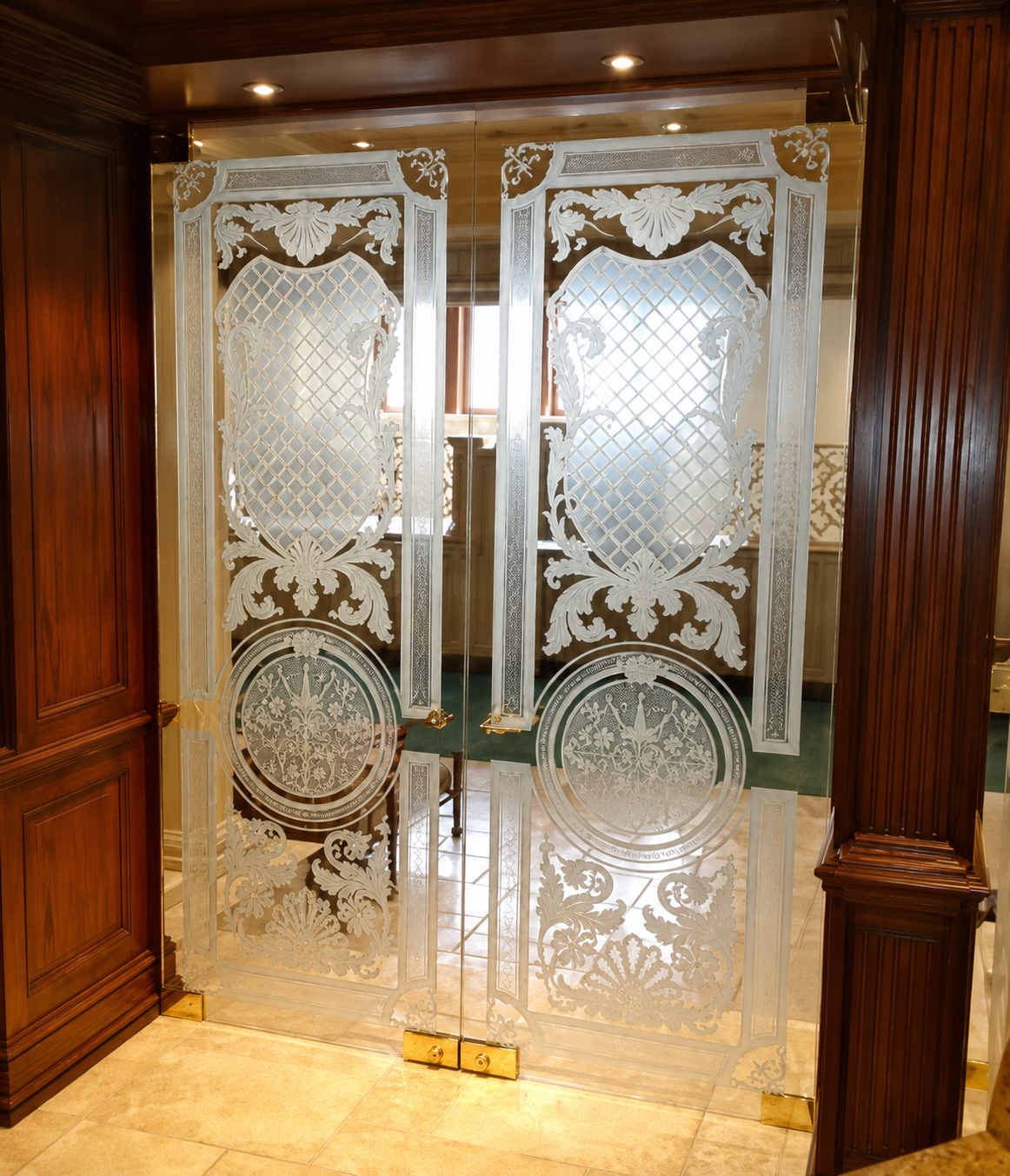 Ornate frosted glass double doors with gold accents in a wood-paneled hallway