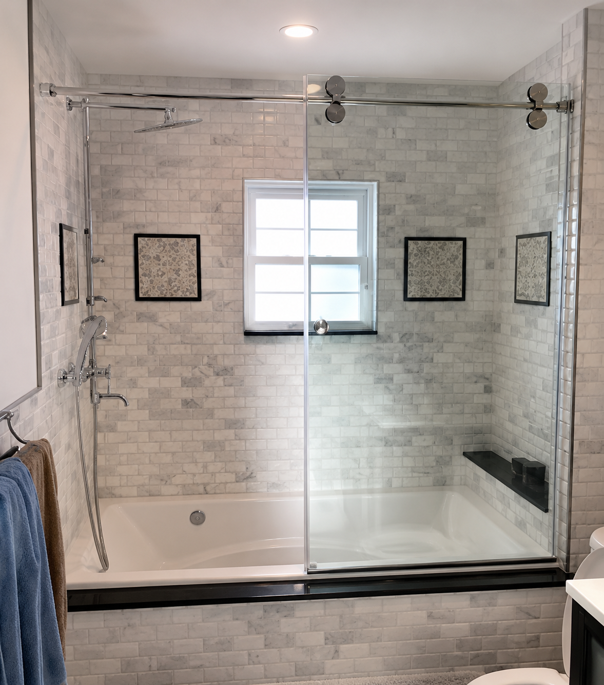 Modern bathroom with tiled walk-in shower, glass doors, window, and built-in bench.