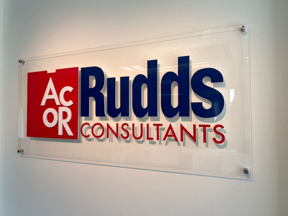 Acrylic sign for AcOR Rudds Consultants, with red and blue lettering. — Capital Signs in Fyshwick, ACT