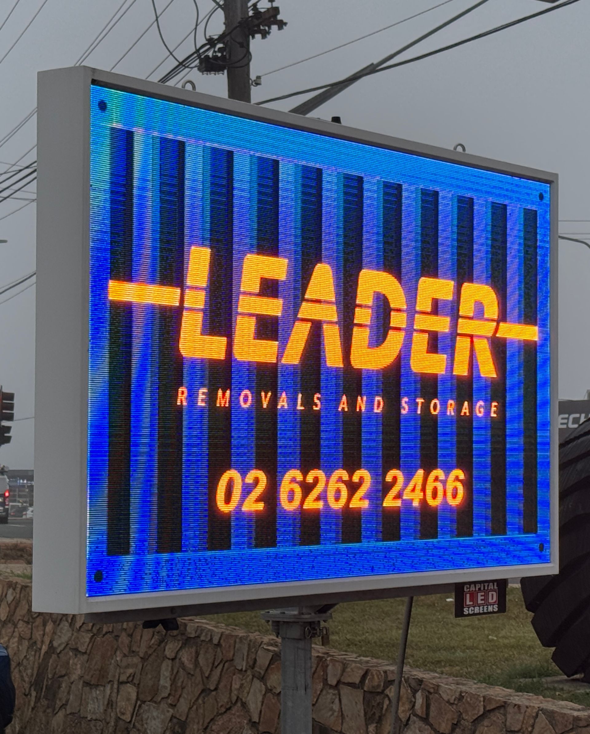 LED sign for Leader Removals and Storage with logo, phone number, and blue and orange colour scheme — Capital Signs in Fyshwick, ACT