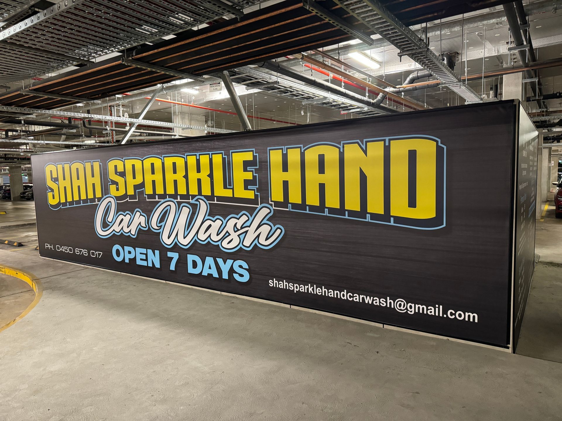 Banner ad for Shah Sparkle Hand Car Wash, open 7 days a week, with contact information — Capital Signs in Fyshwick, ACT