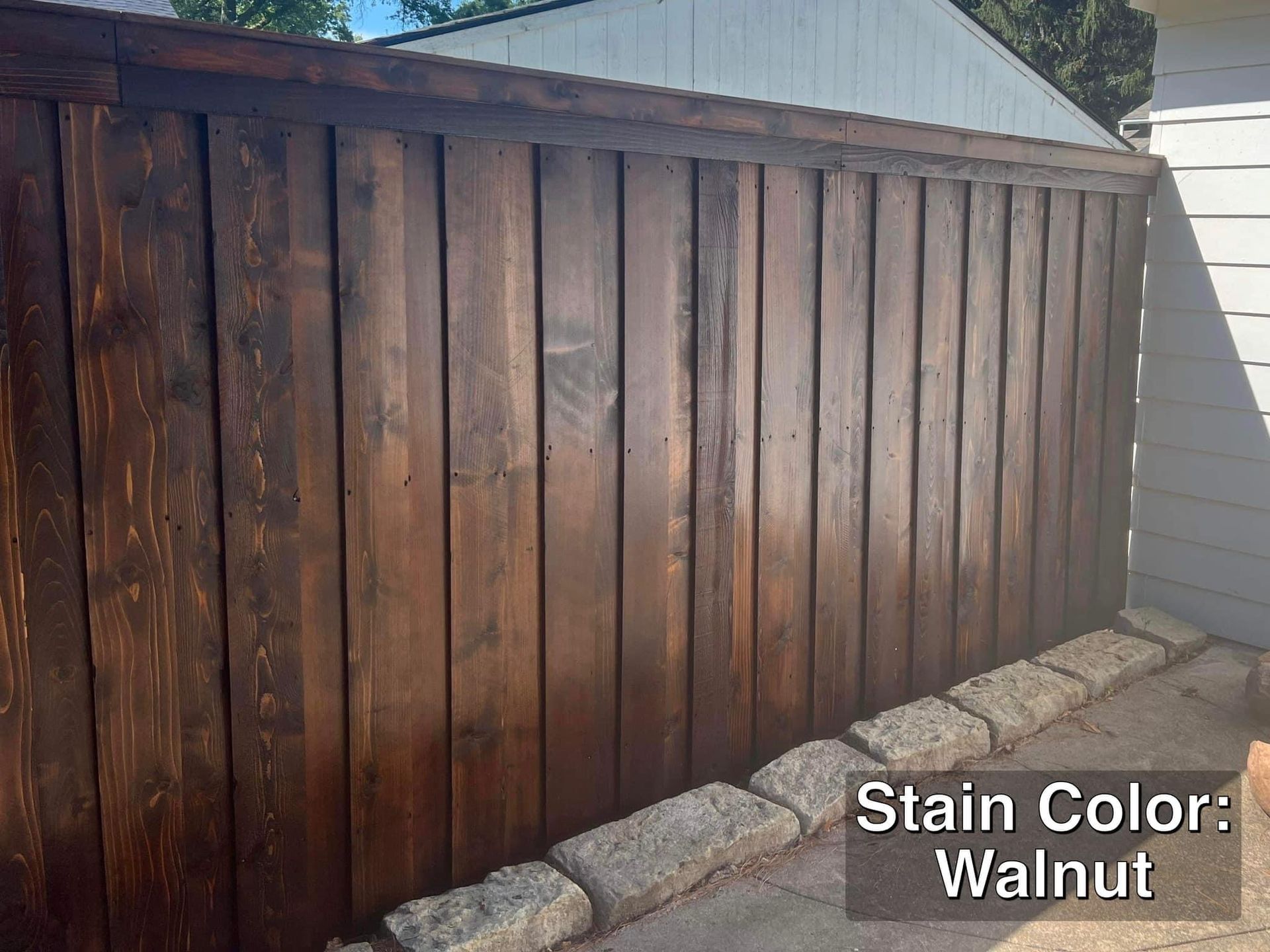 Dark brown walnut stained wooden fence.