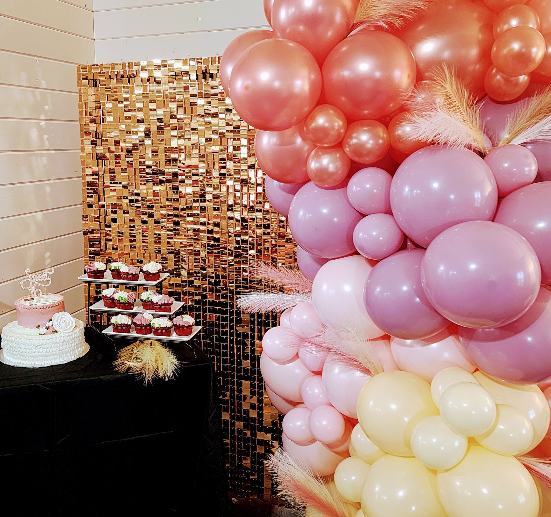 Custom pink and coral organic balloon garland with gold shimmer wall backdrop rental for event in San Antonio and Wilson County TX