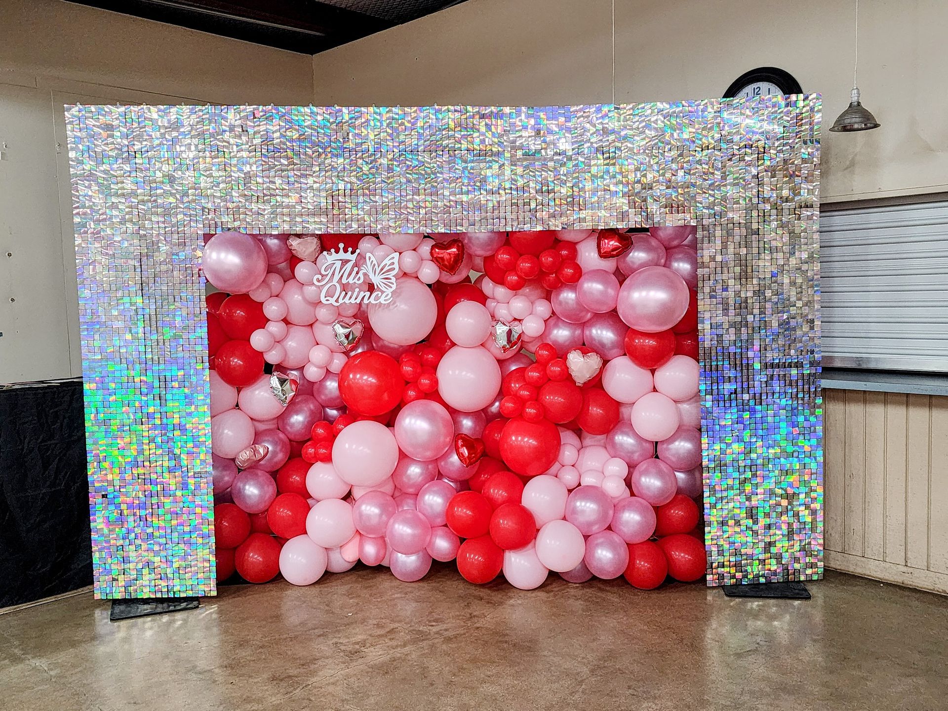 Custom red, pink, and white organic balloon wall with shimmer backdrop frame rental for event in South Texas