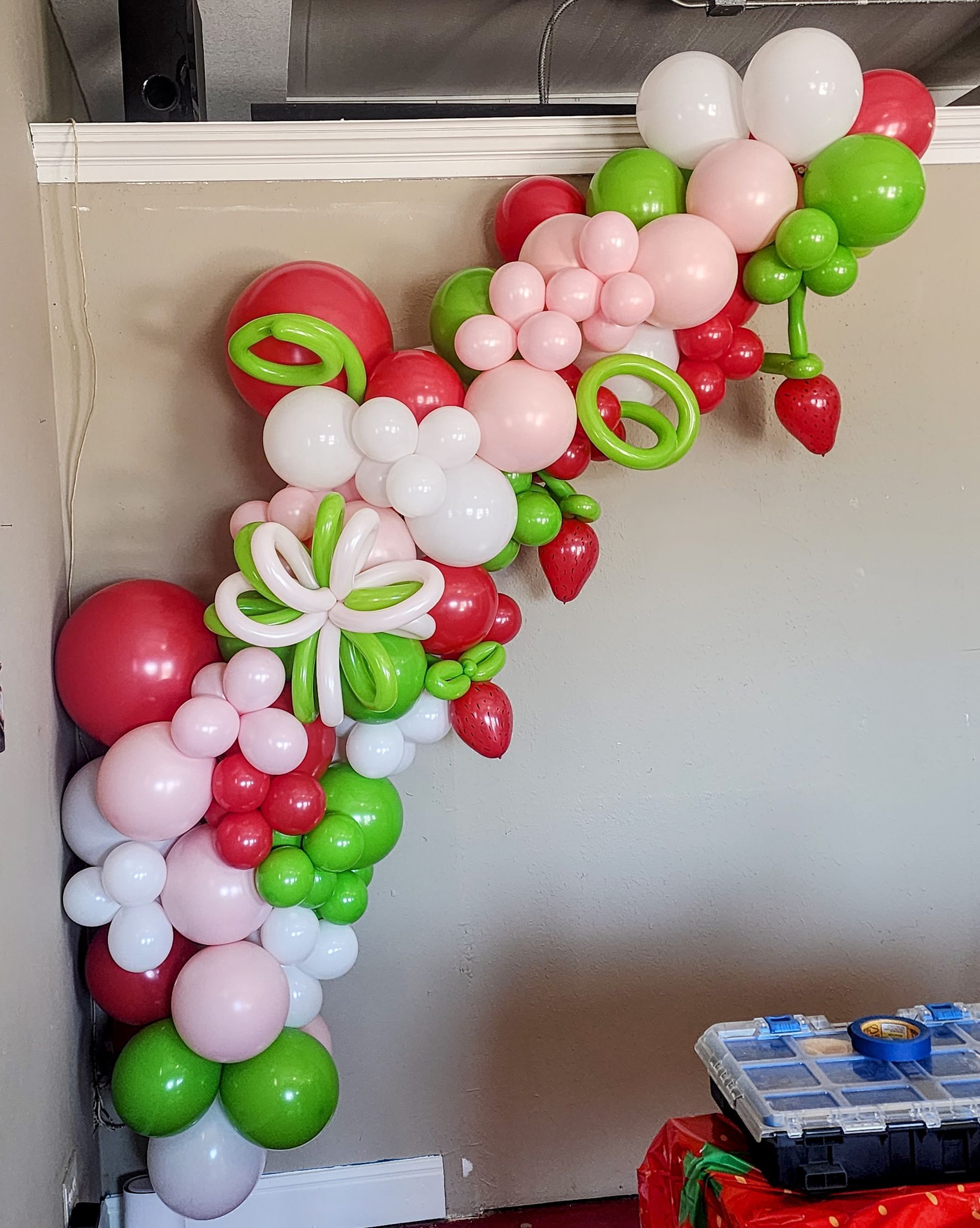 Custom strawberry themed organic balloon garland with specialty accents for event in Pleasanton and South Texas