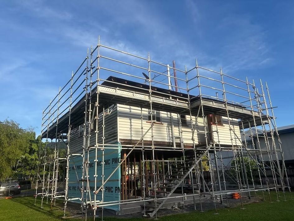 Construction Workers on Scaffolding Against a Blue Sky — Underdog Edge Protection in Redlynch, QLD