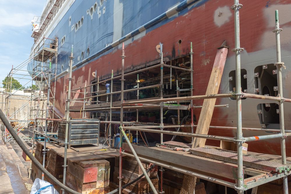 Ship Hull in Drydock With Scaffolding, Undergoing Repair Work — Underdog Edge Protection in Redlynch, QLD