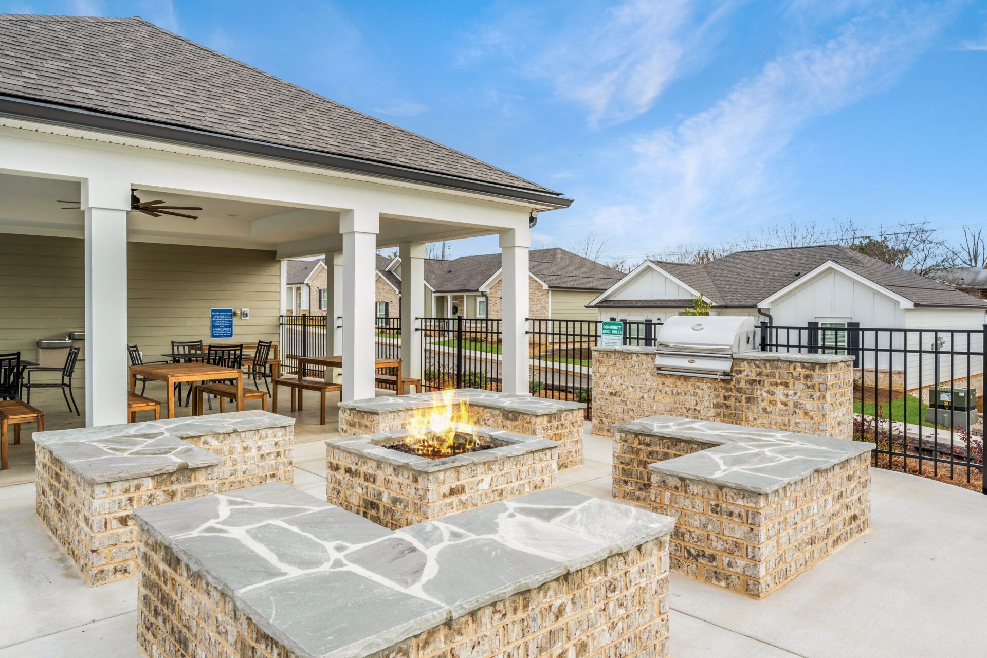 There is a fire pit in the middle of the patio.