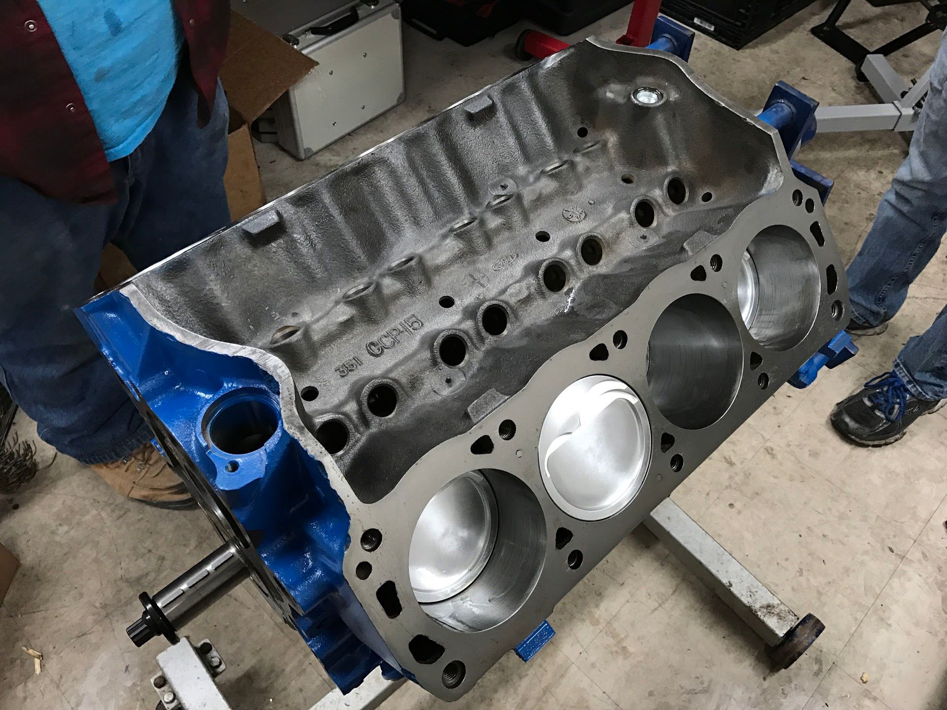 Blue engine block being worked on, in a garage setting. | YellowHammer Racing