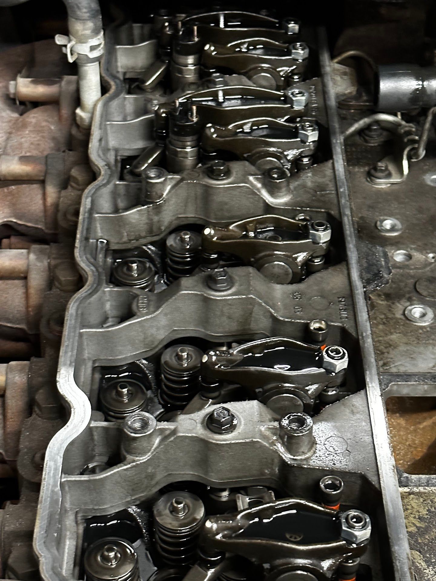 Engine cylinder head with rocker arms, springs, and oil. | YellowHammer Racing
