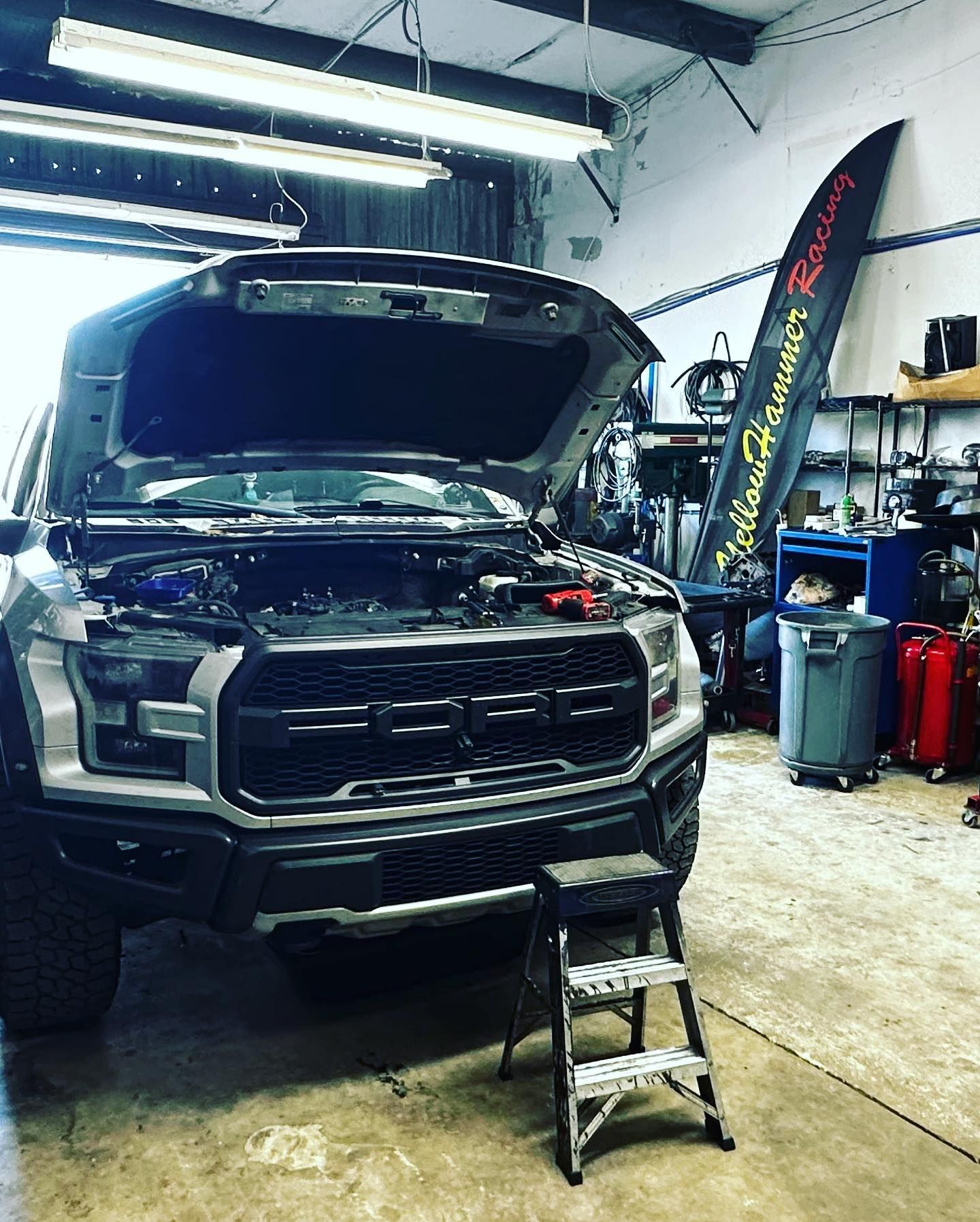 Gray Ford Raptor with open hood in a garage, step stool in front.  | YellowHammer Racing