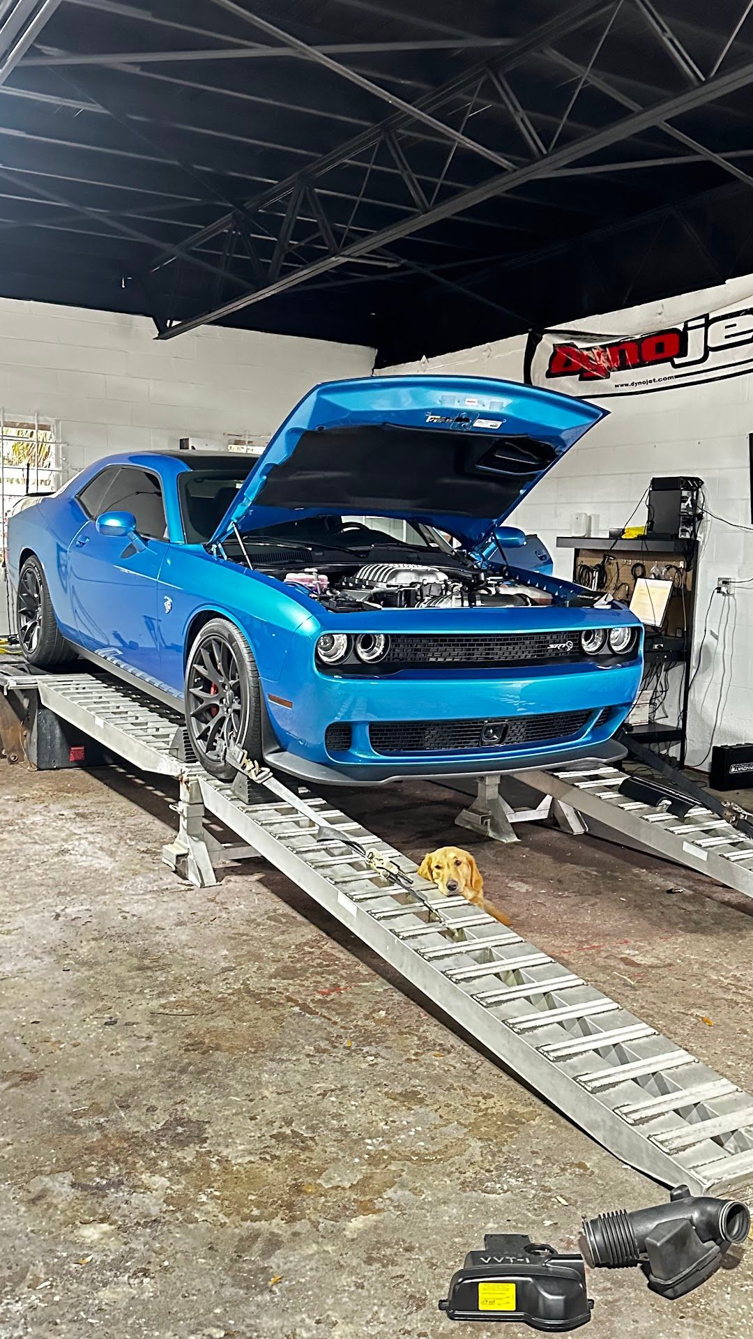 Blue Dodge Challenger on a ramp with hood open in a garage. | YellowHammer Racing