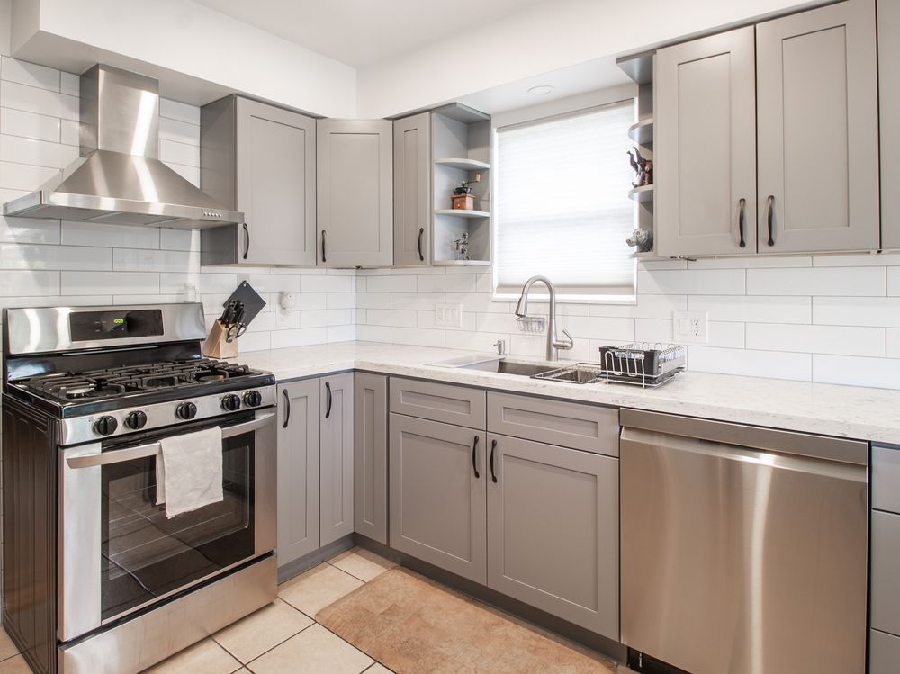Grey and White Kitchen with Stainless Steel Appliances — J & H Plumbing and Gas in Holt, ACT