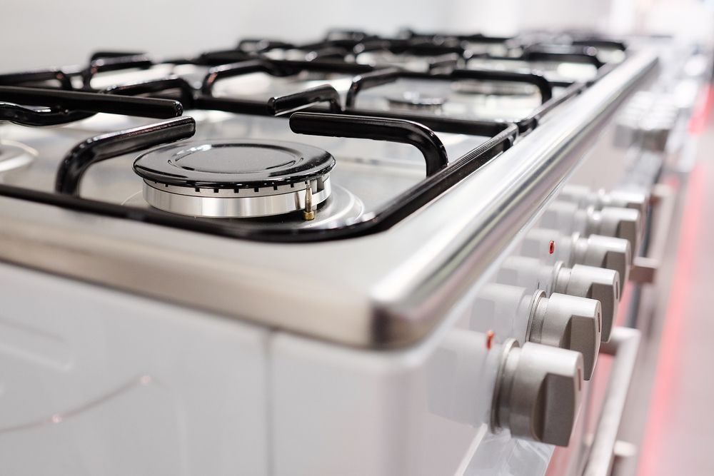 White Gas Range Stove Top with Black Grates — J & H Plumbing and Gas in Gungahlin, ACT