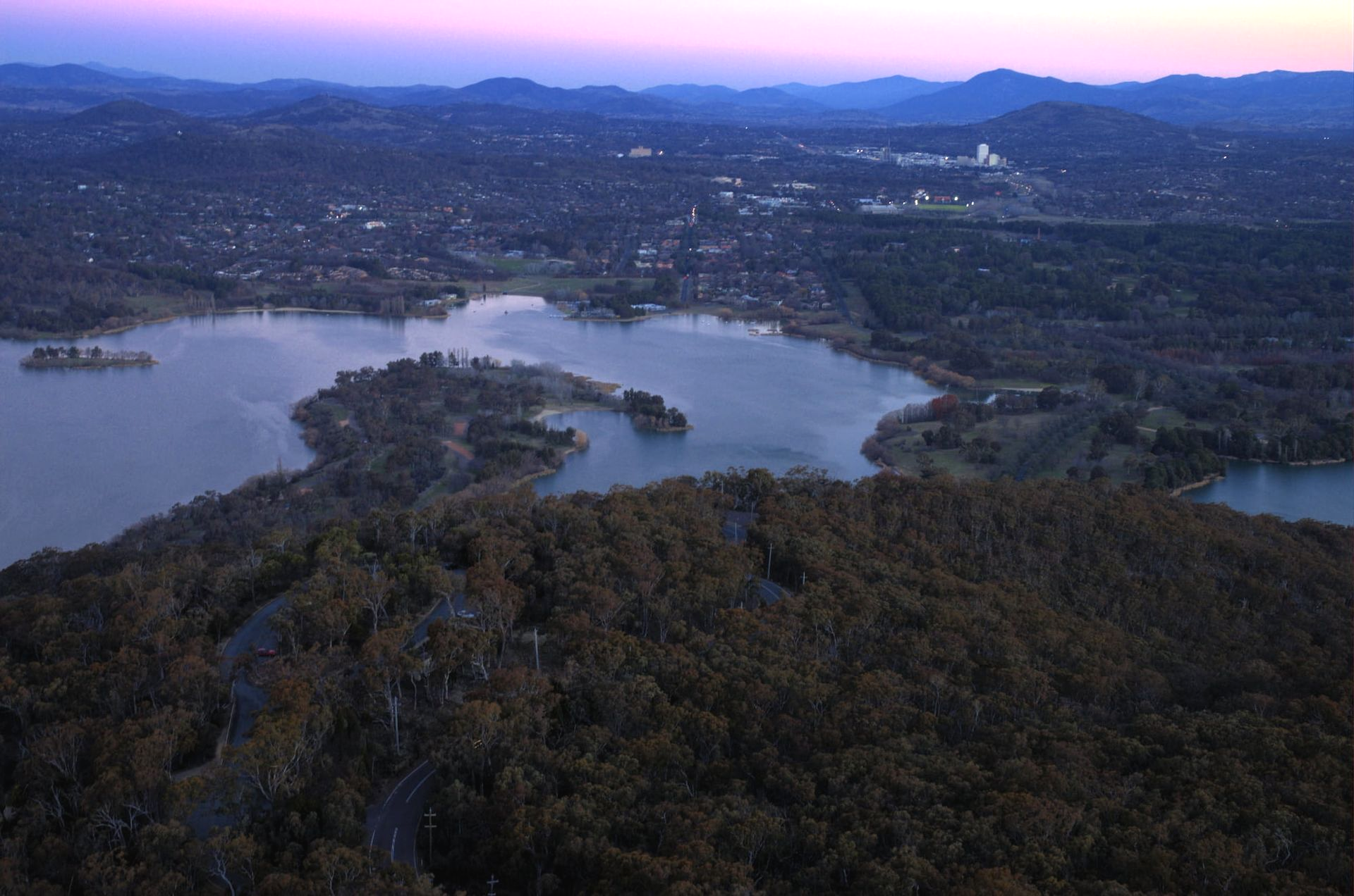 Lake Surrounded by Forested Hills at Dusk — J & H Plumbing and Gas in Woden Valley, ACT