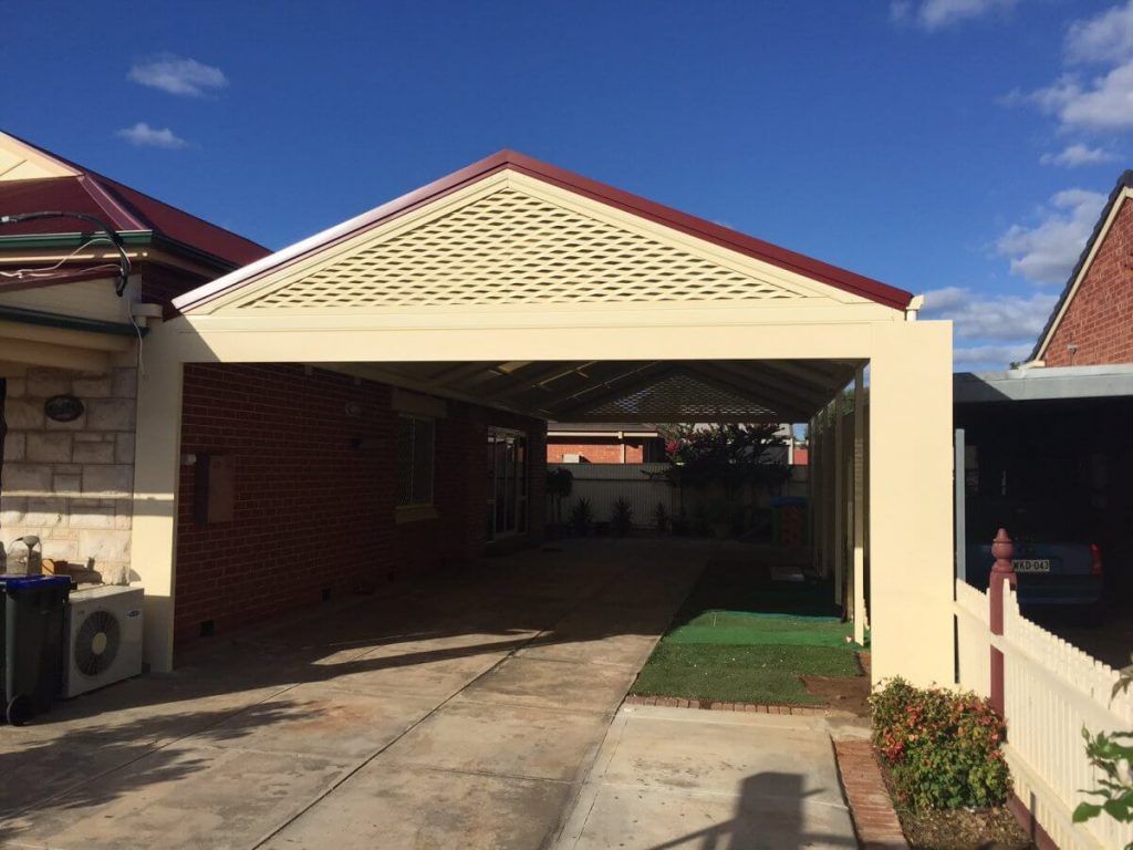 A carport is attached to the side of a house.