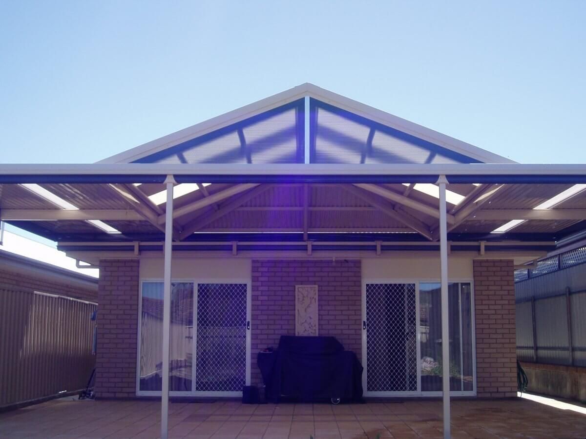 A house with a covered patio and a brick wall