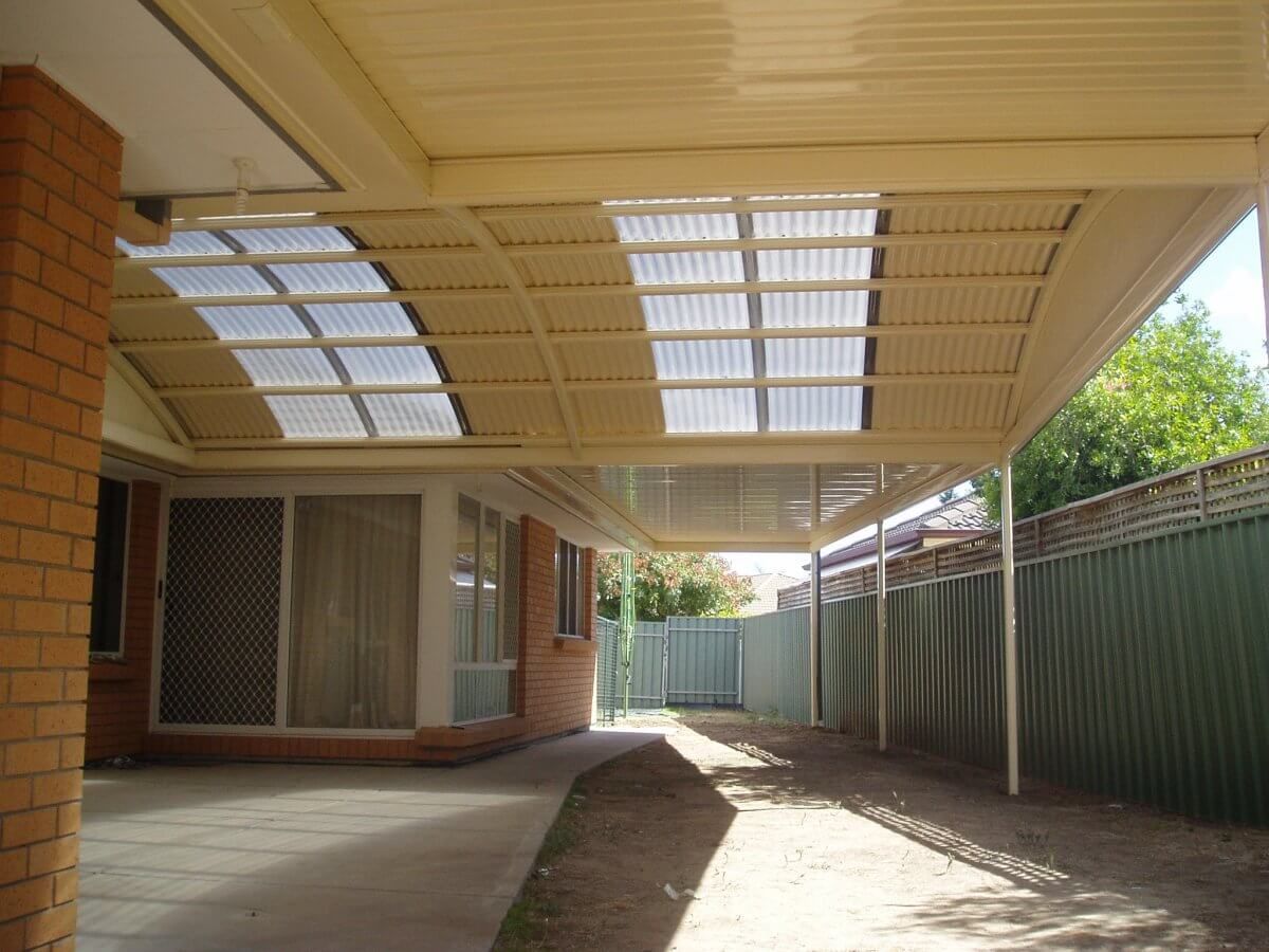 A brick house with a carport underneath it