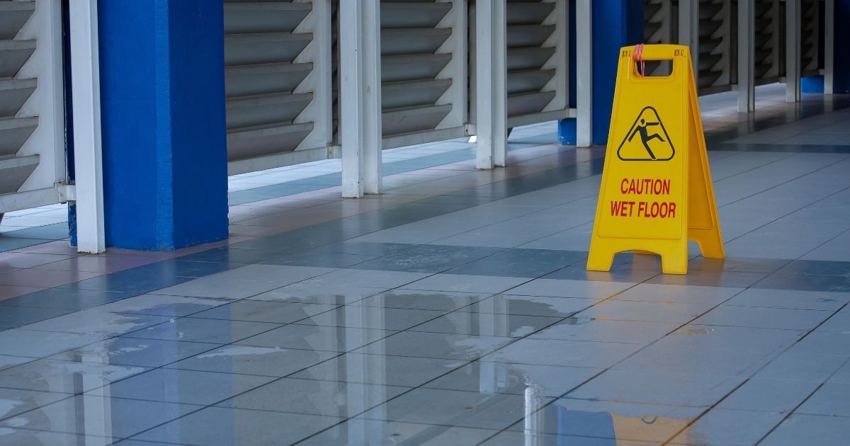 Wet floor caution sign in a store — Alabama slip and fall property owner liability 