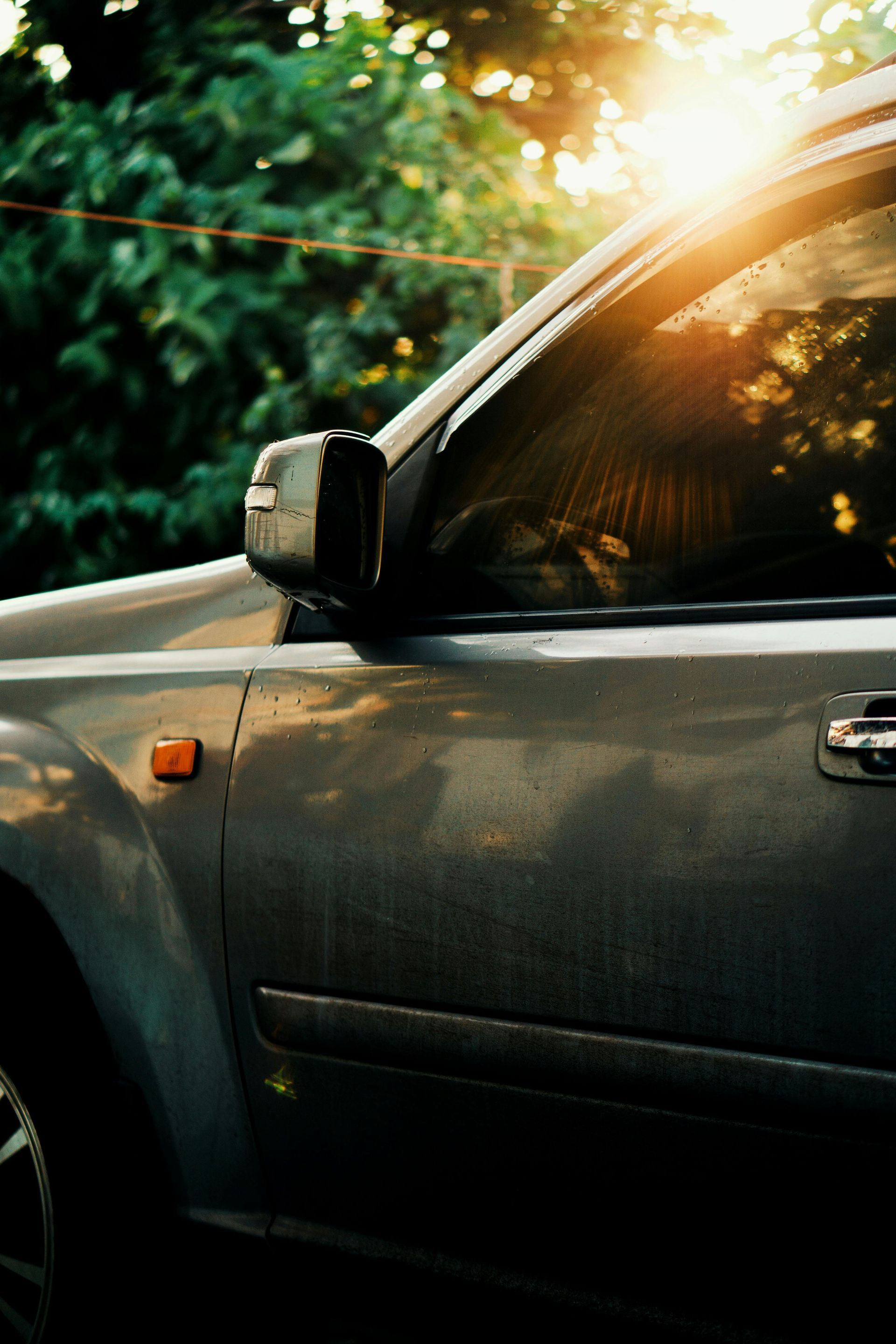 The sun is shining through the window of a car