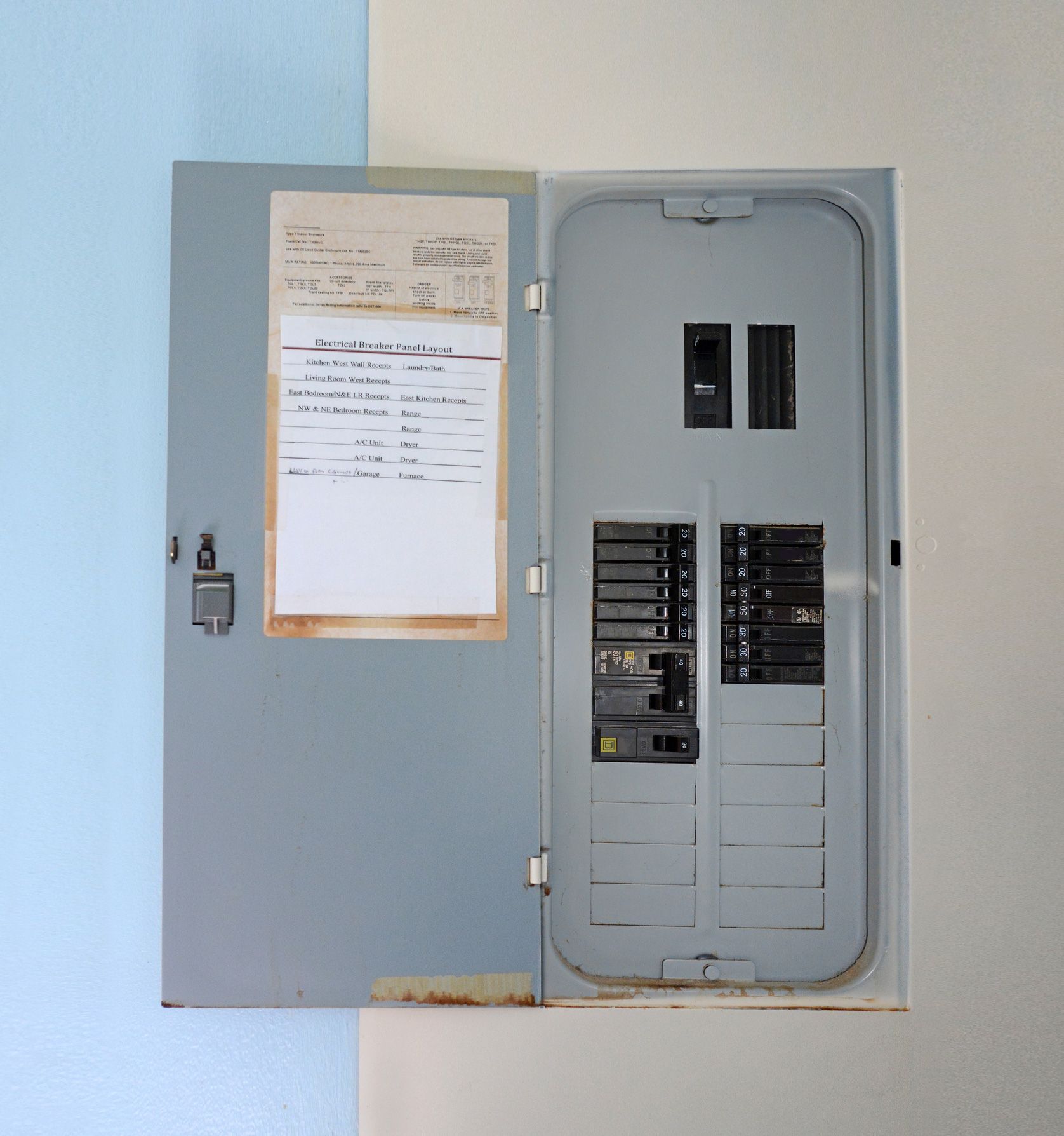 An open electrical box with a piece of paper on it